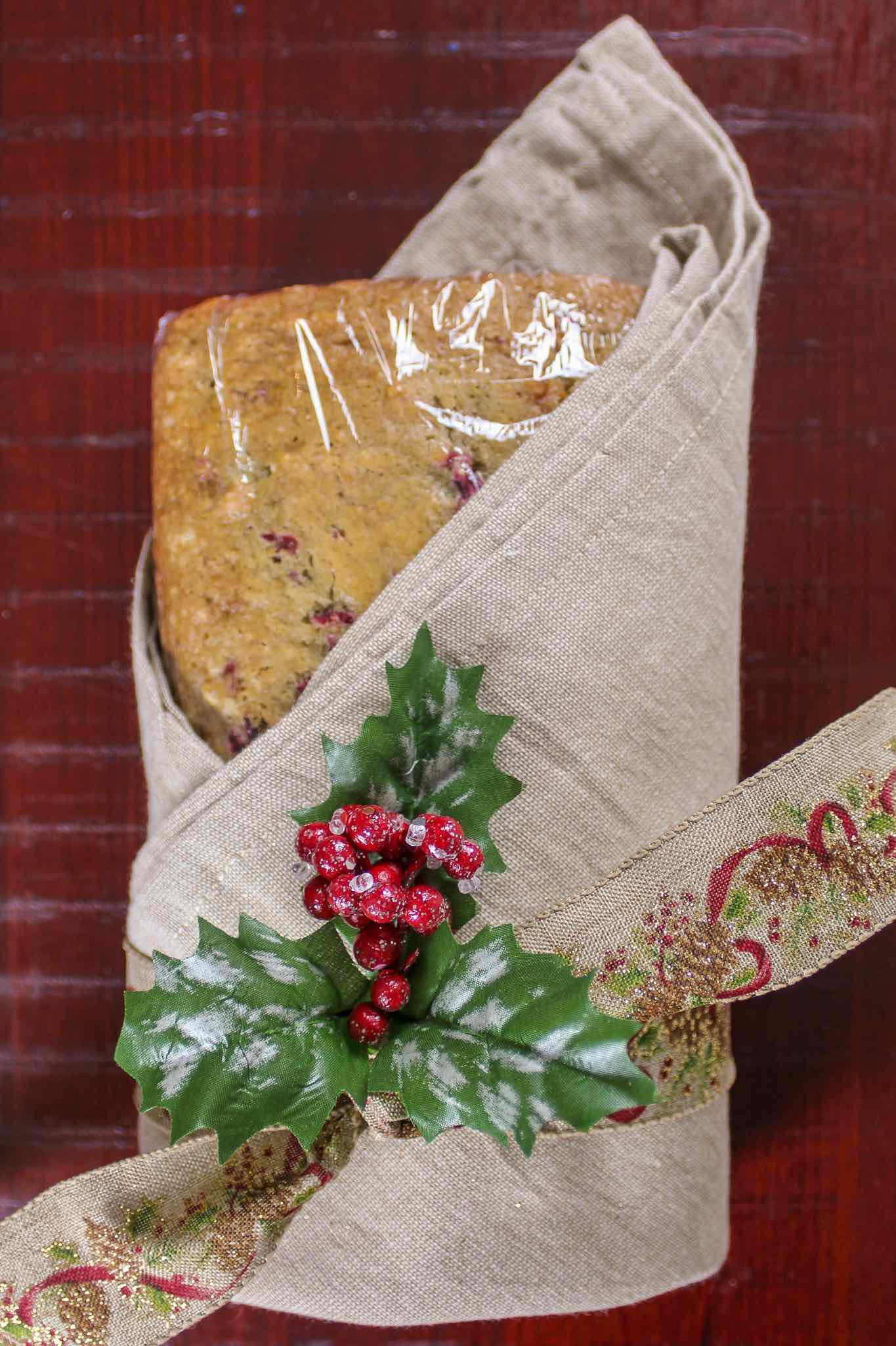 cranberry nut bread wrapped in cloth and tied with a ribbon