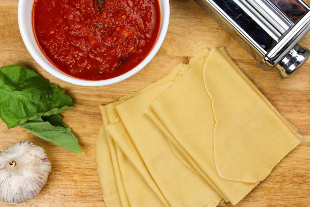 spinach lasagna ingredients including garlic, basil, marinara, and pasta